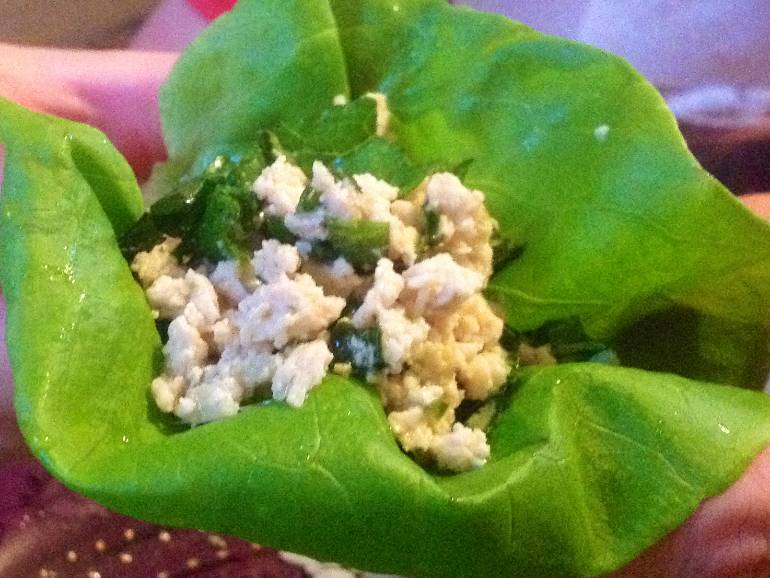 Closeup of chicken larb on a butter lettuce leaf.